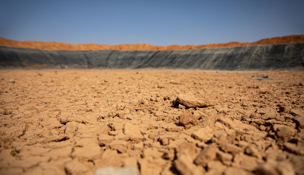 Once filled with over 150,000 barrels of water, this ActionAid-implemented earth dam in Beerato, Somaliland is now completely dry due to failed rains and increasing temperatures.