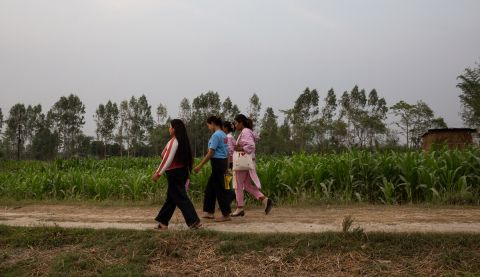Women in Nepal, walking in a field