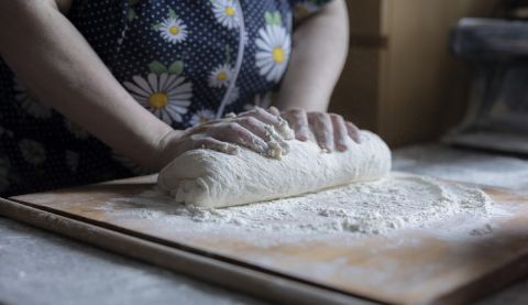 A woman kneading dough