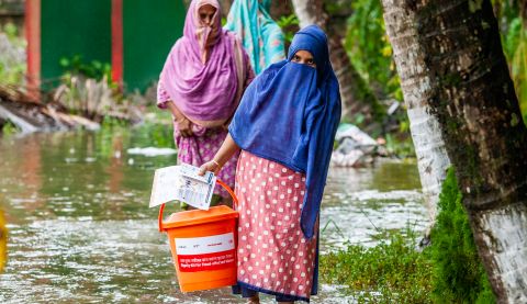 Women carrying supplies during the floods in Bangladesh