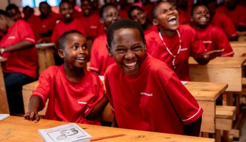 Girls laughing in a classroom at a school in Rwanda