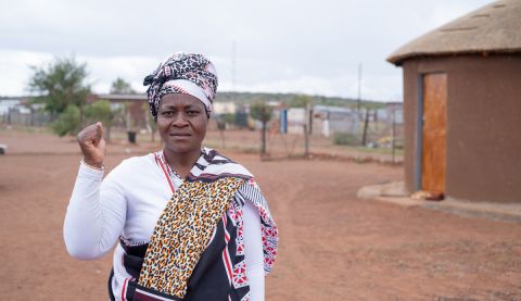 A woman holding up a fist in the air
