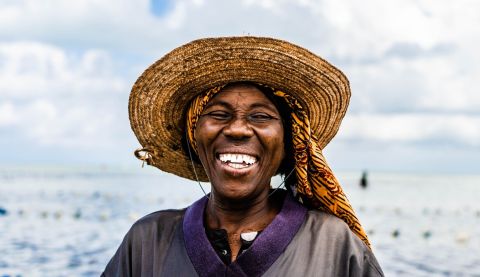 Fisherwoman looking at camera and laughing