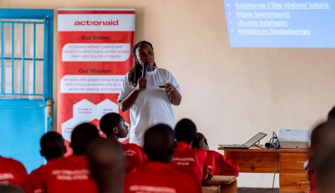 A woman giving a talk to classroom of girls