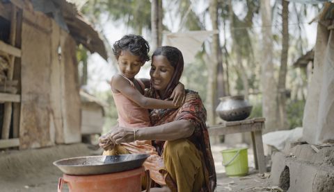 Woman with her child cooking a meal