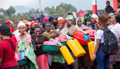 women collecting hygiene kits from other women leaders 