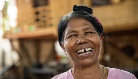 A woman laughing to camera in Myanmar