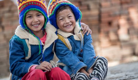 Kristina and Krishla, from Nepal, have received coats and hats from ActionAid