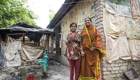 woman and daughter outside their house