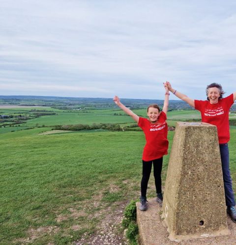 Woman and child celebrating with hands in the air