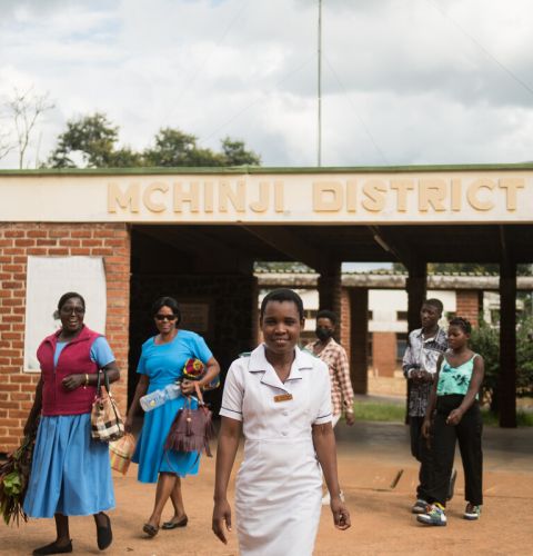 Nurses in Malawi leaving a hospital and smiling