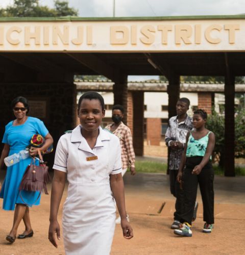 Nurses in Malawi leaving a hospital and smiling