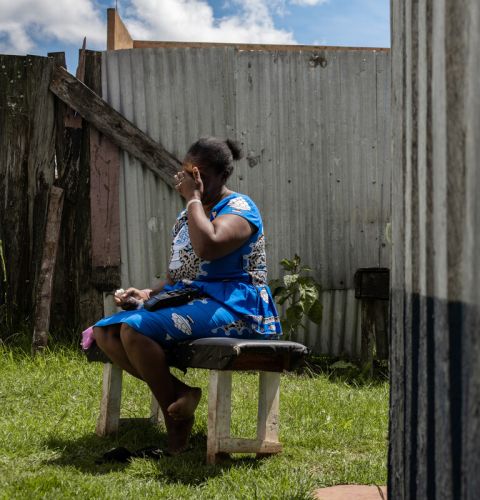 Woman on a bench covering her face