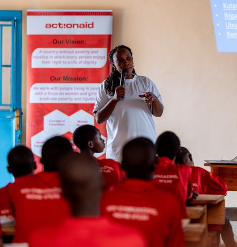 A woman giving a talk to classroom of girls