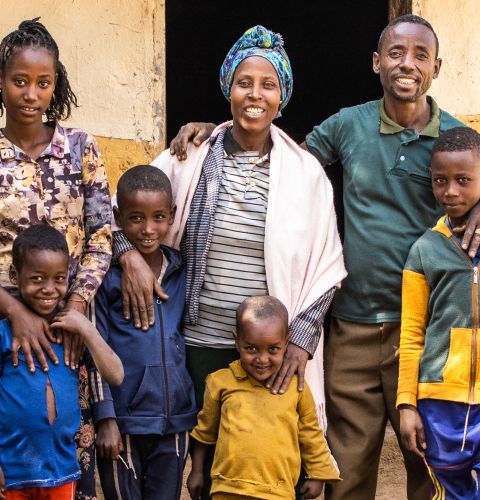 a family posing for a photo in front of their house