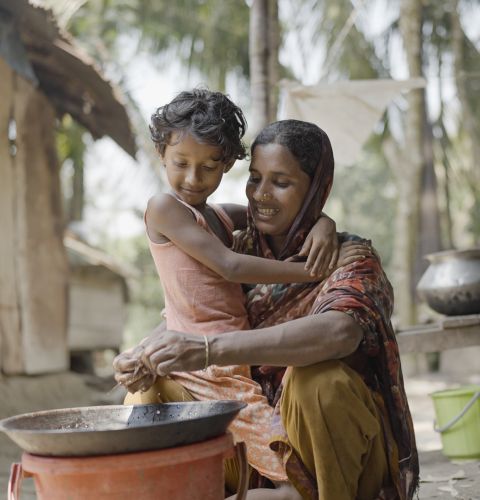 Woman with her child cooking a meal