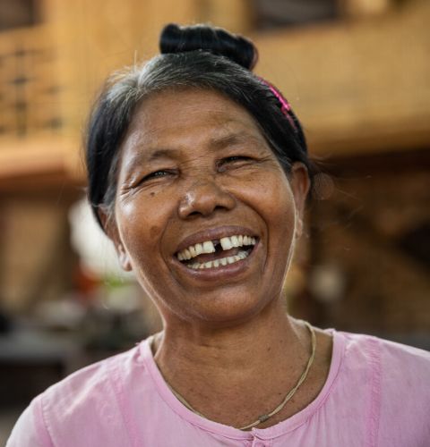A woman laughing to camera in Myanmar