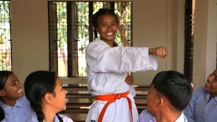 Girl in karate uniform at school