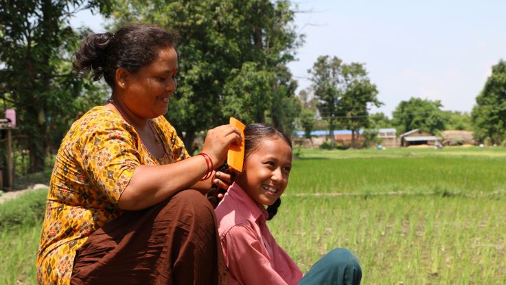 Rejina with her mother prepping for school.
