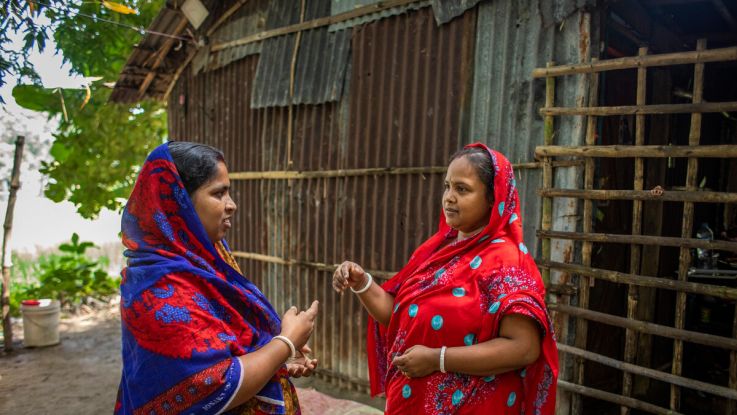 Two women talking to each other face to face