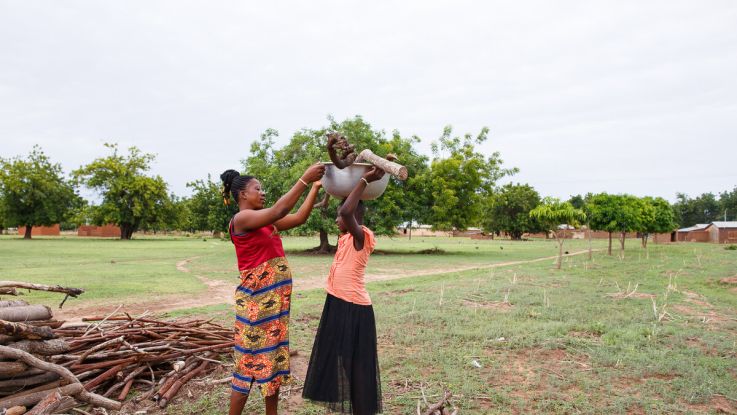 Woman helping a girl