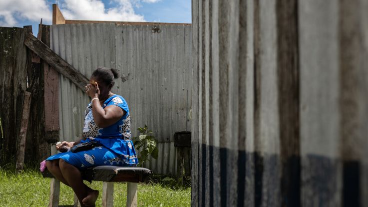 Woman on a bench covering her face