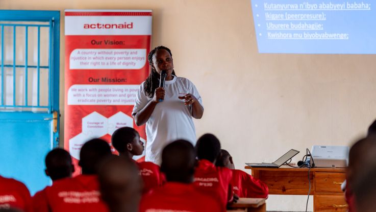 A woman giving a talk to classroom of girls
