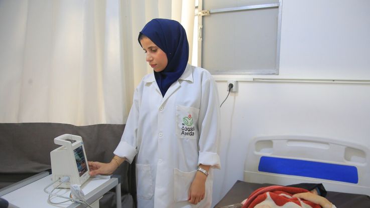 A nurse in uniform standing in a hospital