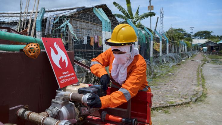 Woman in fire uniform preparing for crises