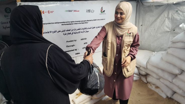 Woman handing a bag to another woman