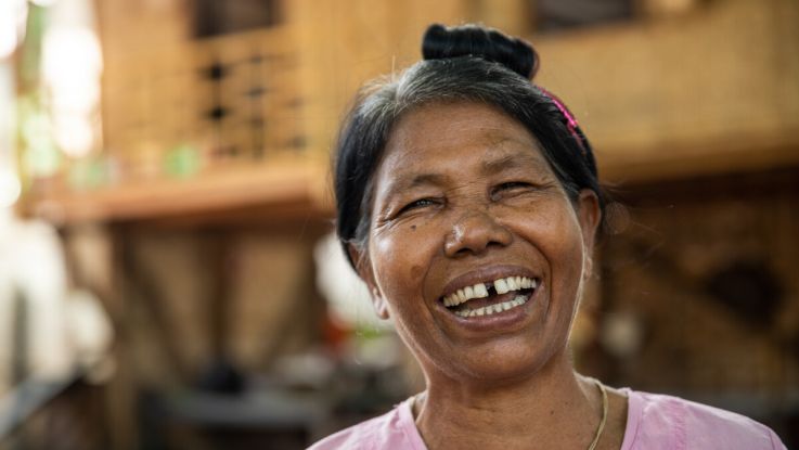 A woman laughing to camera in Myanmar