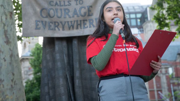 Community Campaigner speaking at podium