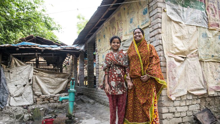 woman and daughter outside their house