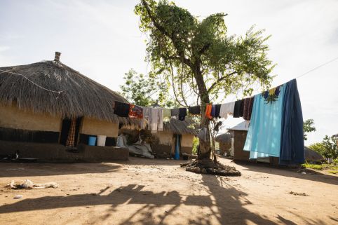 Picture of a house in Uganda with clothes hanging outside.